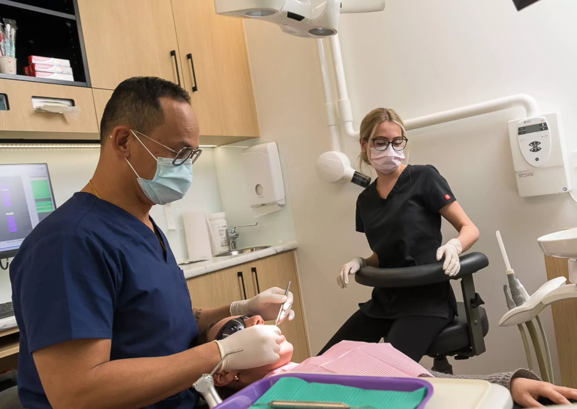 Gentle Dental staff conduct dental examination