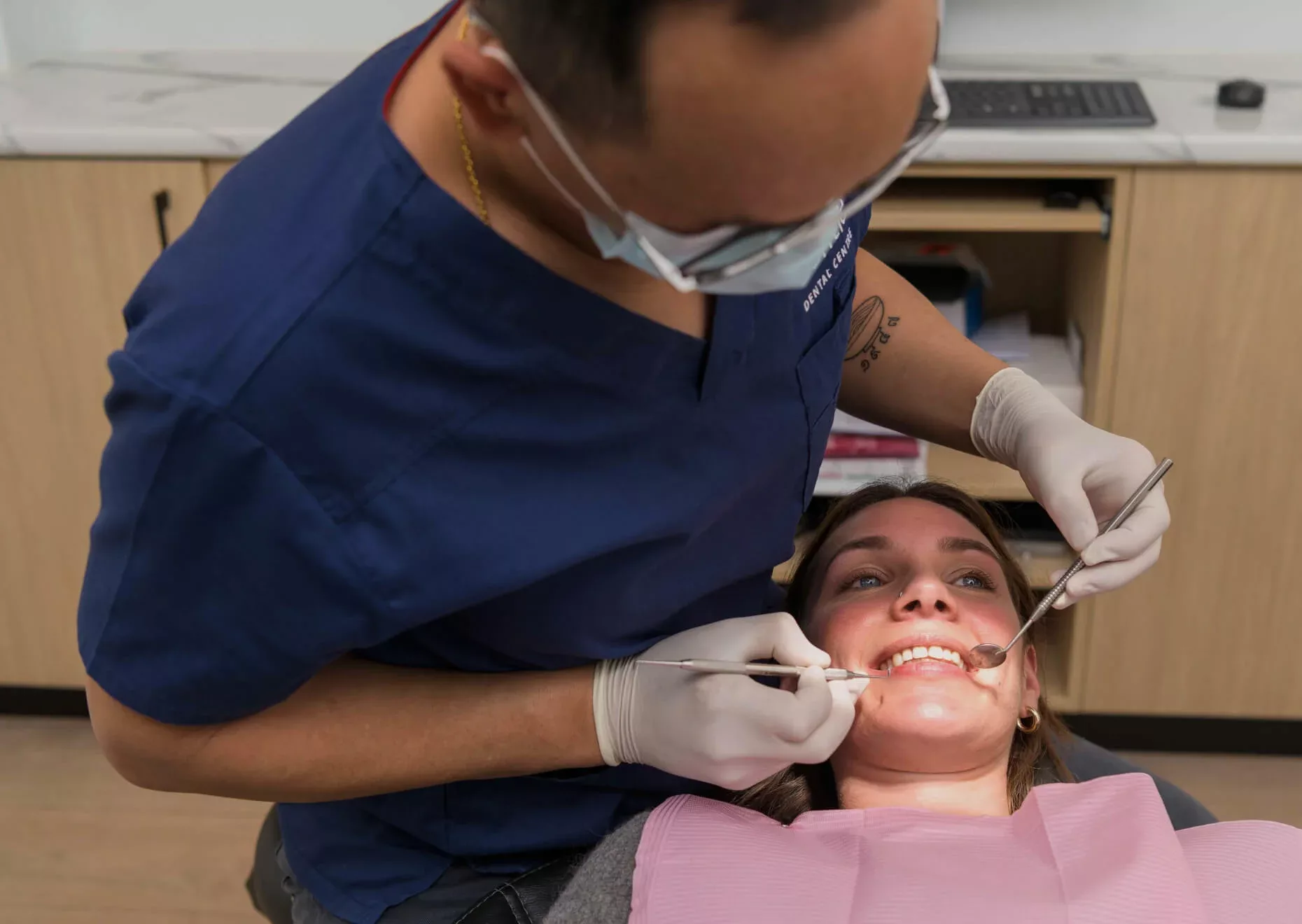 Gentle Dental dentist examines patient